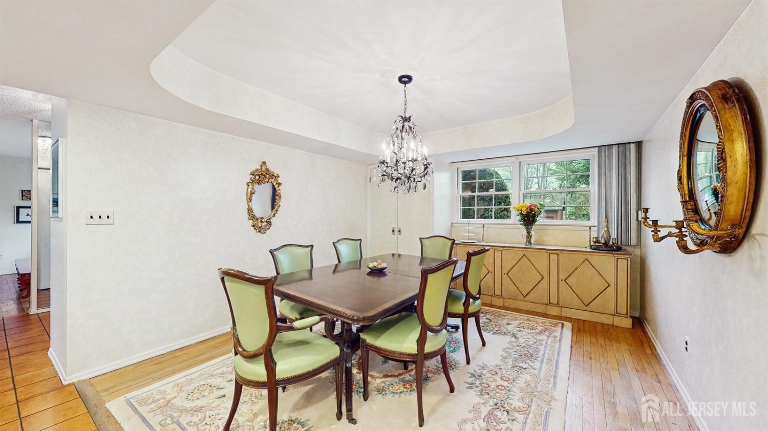 4 Whitewood Road Edison, NJ 08820 - Photo 12 of 31 a view of a dining room with furniture a chandelier and wooden floor
