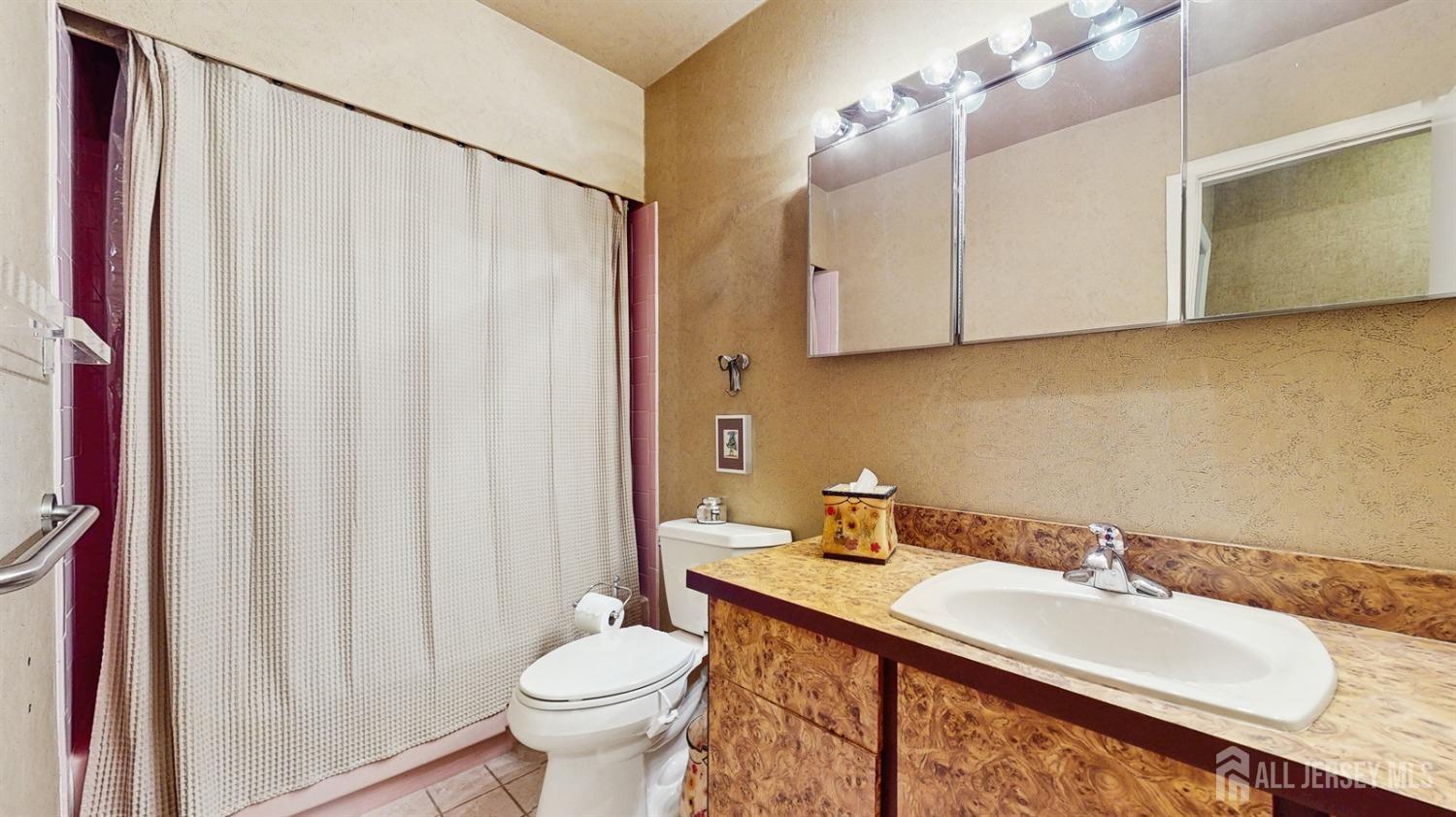 4 Whitewood Road Edison, NJ 08820 - Photo 20 of 31 a bathroom with a granite countertop sink and a mirror