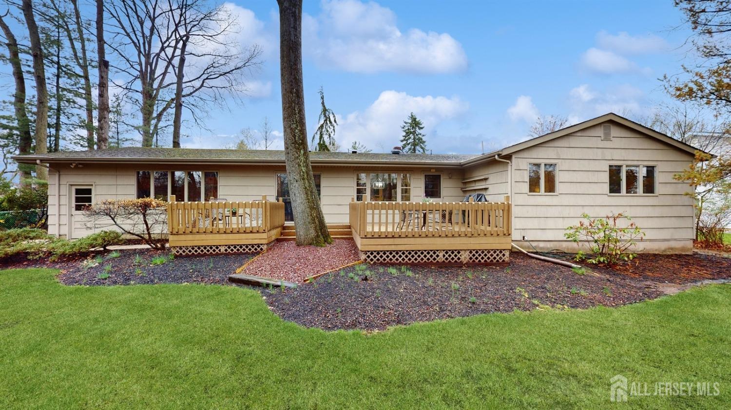 4 Whitewood Road Edison, NJ 08820 - Photo 26 of 31 a white house that has a small yard and large trees