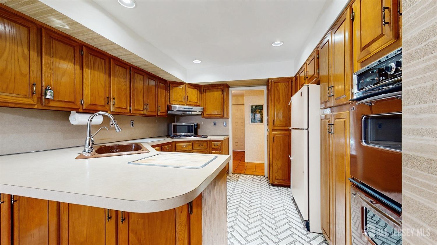 4 Whitewood Road Edison, NJ 08820 - Photo 10 of 31 a kitchen with stainless steel appliances granite countertop a refrigerator a sink and a stove