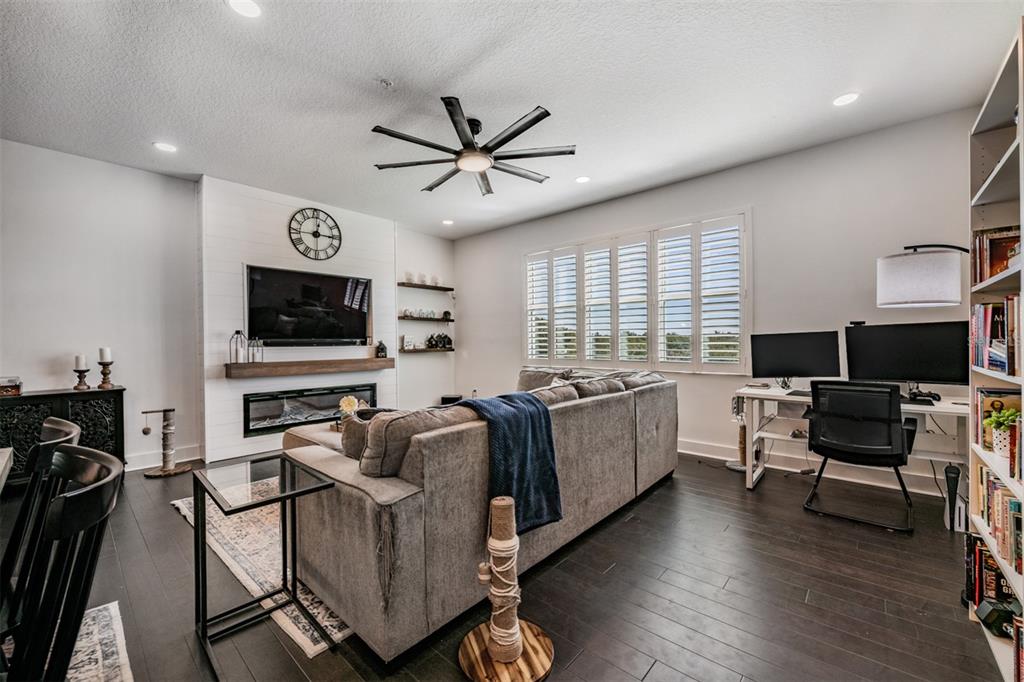 9916 Key Haven Road Seminole, FL 33777 - Photo 12 of 40 a living room with furniture and a flat screen tv