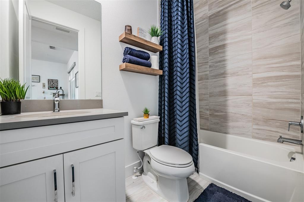 9916 Key Haven Road Seminole, FL 33777 - Photo 14 of 40 a bathroom with a sink a toilet a mirror and bathtub