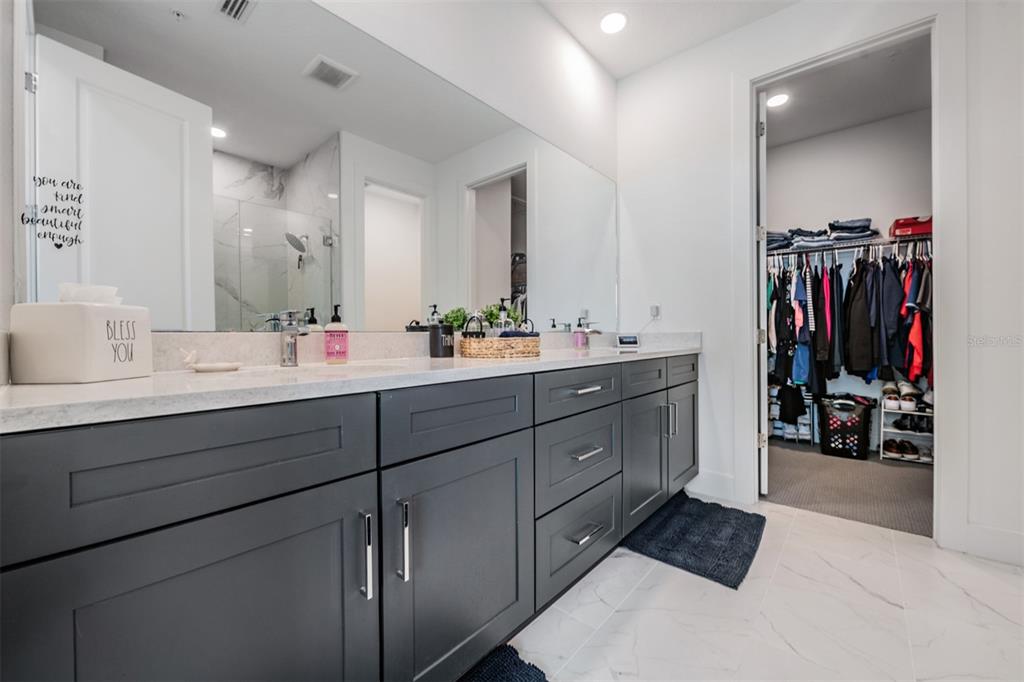 9916 Key Haven Road Seminole, FL 33777 - Photo 18 of 40 a bathroom with a double vanity sink and mirror