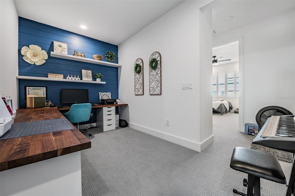 9916 Key Haven Road Seminole, FL 33777 - Photo 20 of 40 a bedroom with furniture and a lamp