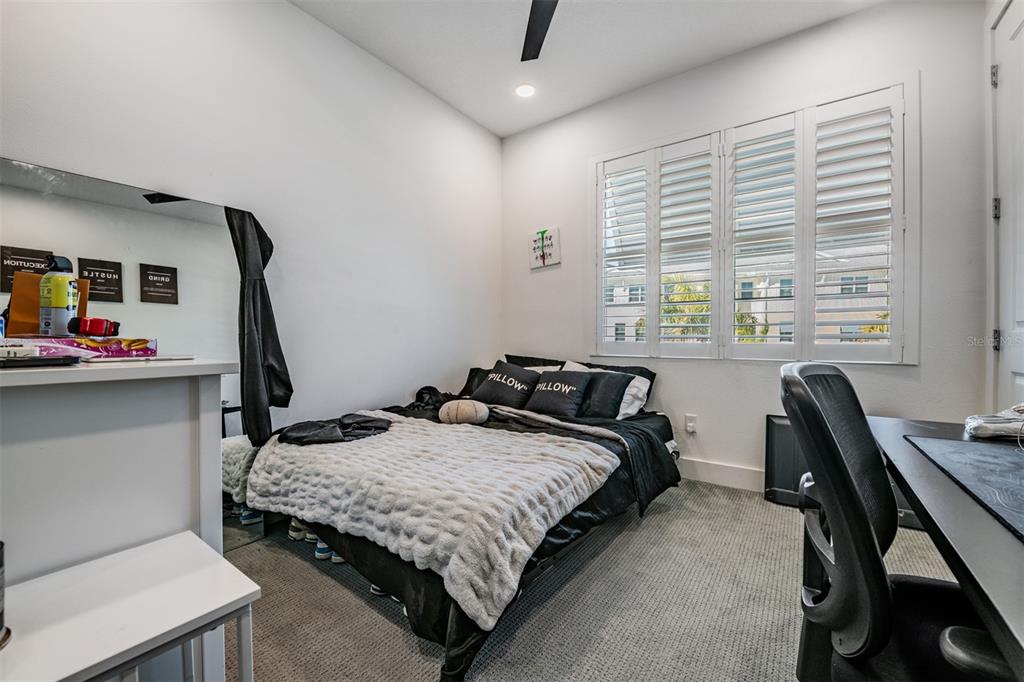 9916 Key Haven Road Seminole, FL 33777 - Photo 22 of 40 a bedroom that has a bed and a desk in it