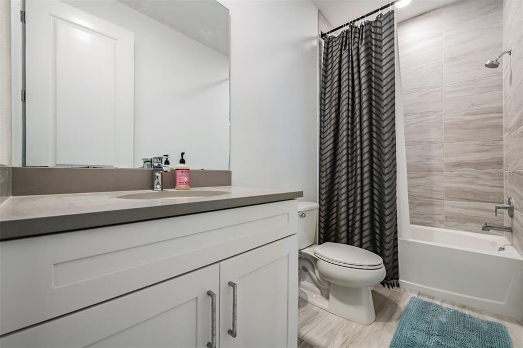 9916 Key Haven Road Seminole, FL 33777 - Photo 23 of 40 a bathroom with a sink toilet and shower