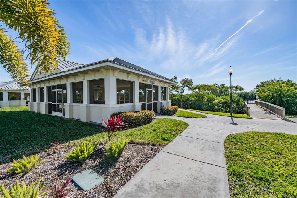 9916 Key Haven Road Seminole, FL 33777 - Photo 29 of 40 a front view of a house with porch and garden