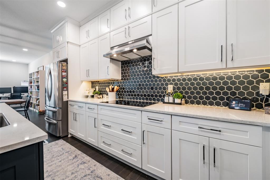 9916 Key Haven Road Seminole, FL 33777 - Photo 4 of 40 a kitchen with white cabinets and sink