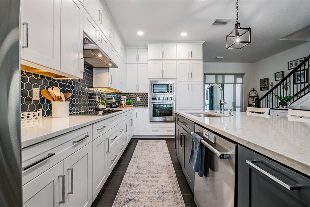 9916 Key Haven Road Seminole, FL 33777 - Photo 5 of 40 a large kitchen with stainless steel appliances lots of counter space and a sink