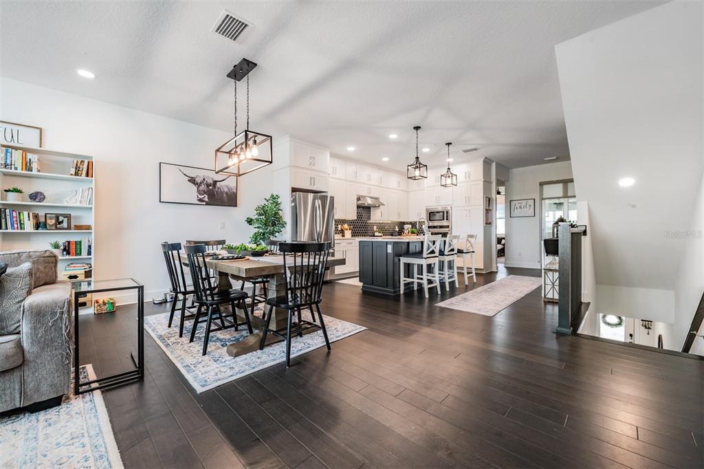 9916 Key Haven Road Seminole, FL 33777 - Photo 8 of 40 a view of a dining room with furniture wooden floor and chandelier