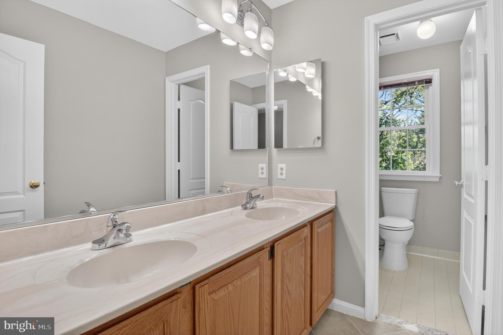 11601 Letterman Way Gaithersburg, MD 20878 - Photo 30 of 53 a bathroom with a sink a toilet and a mirror