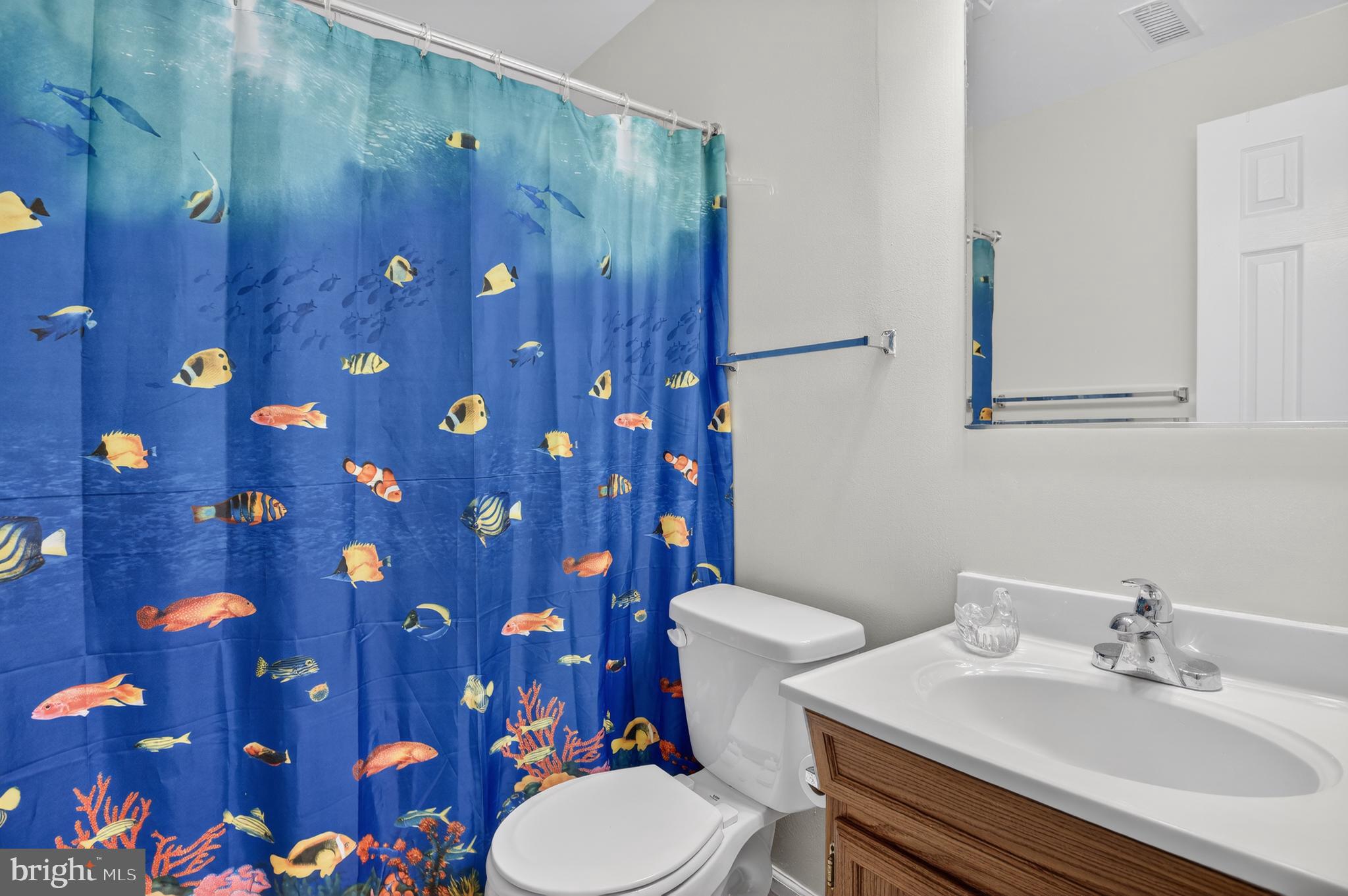 11601 Letterman Way Gaithersburg, MD 20878 - Photo 36 of 53 a bathroom with a sink a toilet and shower curtain