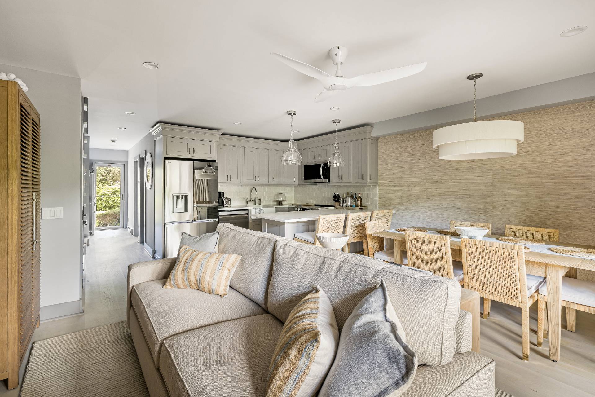 a living room with furniture and a view of kitchen