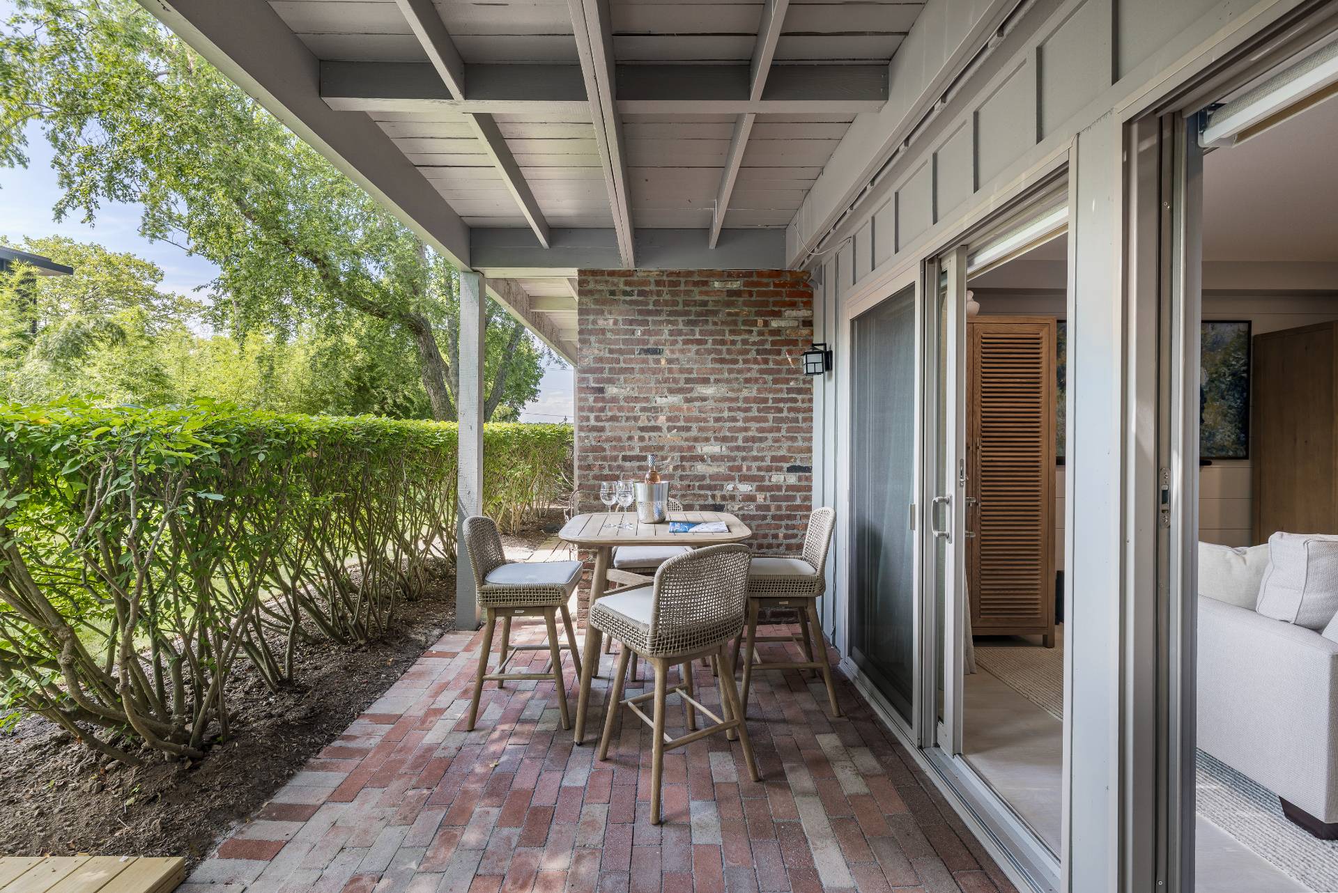 18 Bridge Street, Unit 3E Sag Harbor, NY 11963 - Photo 15 of 22 a view of a patio with table and chairs and wooden floor