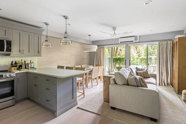 a living room with furniture and large windows