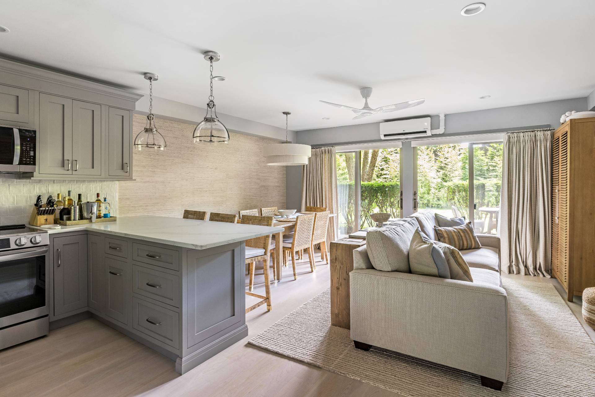 18 Bridge Street, Unit 3E Sag Harbor, NY 11963 - Photo 6 of 22 a living room with furniture and large windows