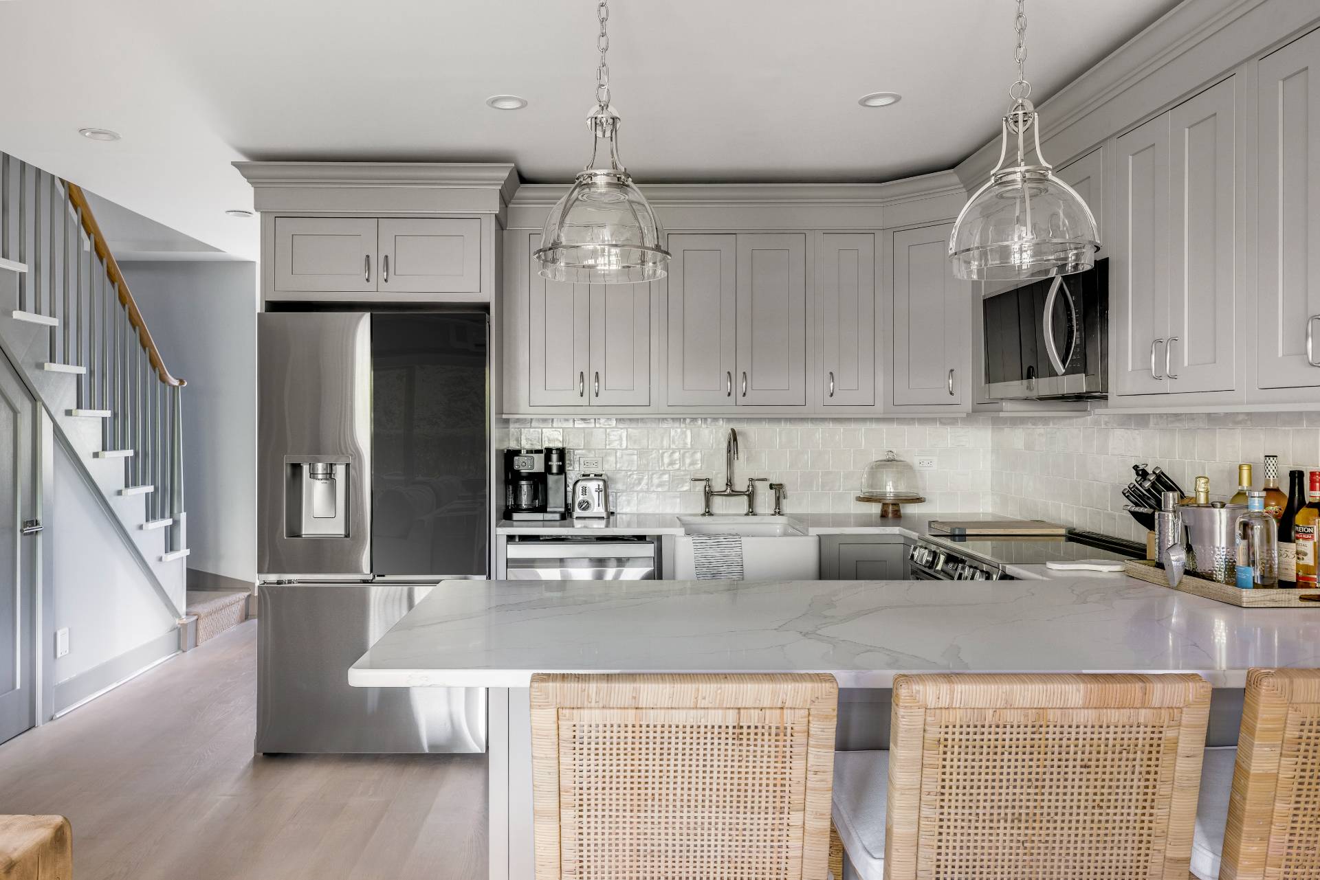 18 Bridge Street, Unit 3E Sag Harbor, NY 11963 - Photo 7 of 22 a kitchen with stainless steel appliances granite countertop a sink refrigerator and cabinets