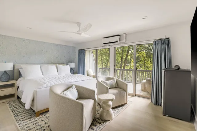 a bedroom with a bed and glass window