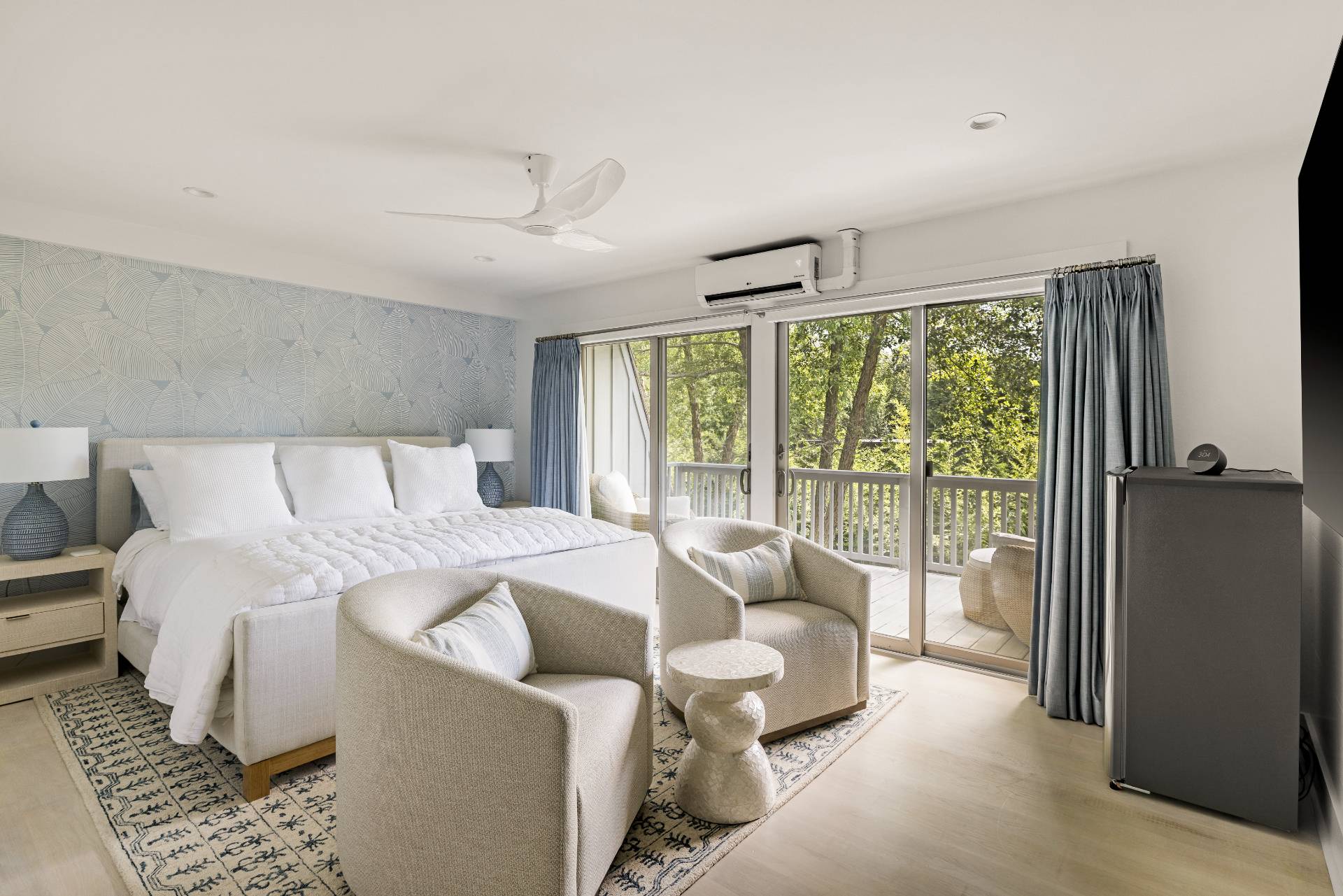 18 Bridge Street, Unit 3E Sag Harbor, NY 11963 - Photo 10 of 22 a bedroom with a bed and glass window