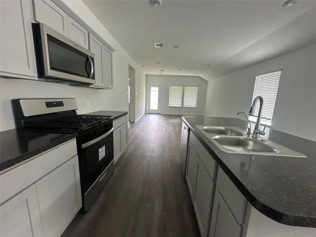 a kitchen that has a sink and a stove