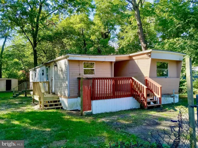 a view of backyard with a garden and deck