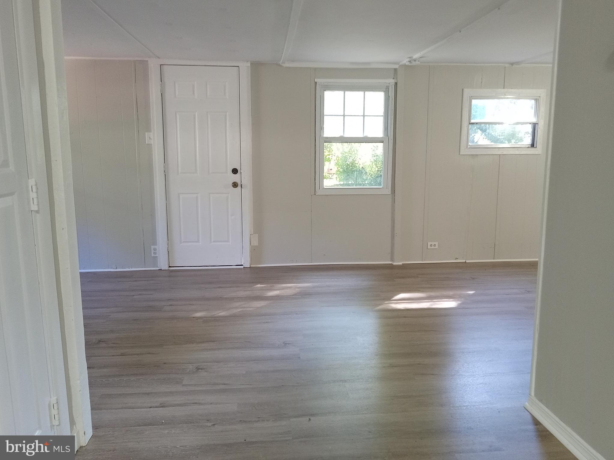 1761 Spring Garden Road Millville, NJ 08332 - Photo 6 of 14 a view of empty room with window and wooden floor