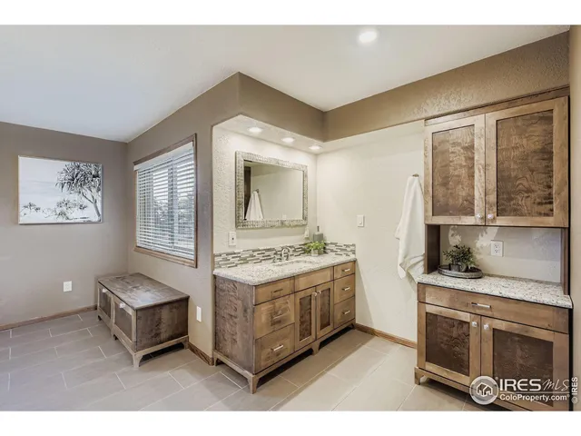 a bathroom with a sink a shower and a mirror