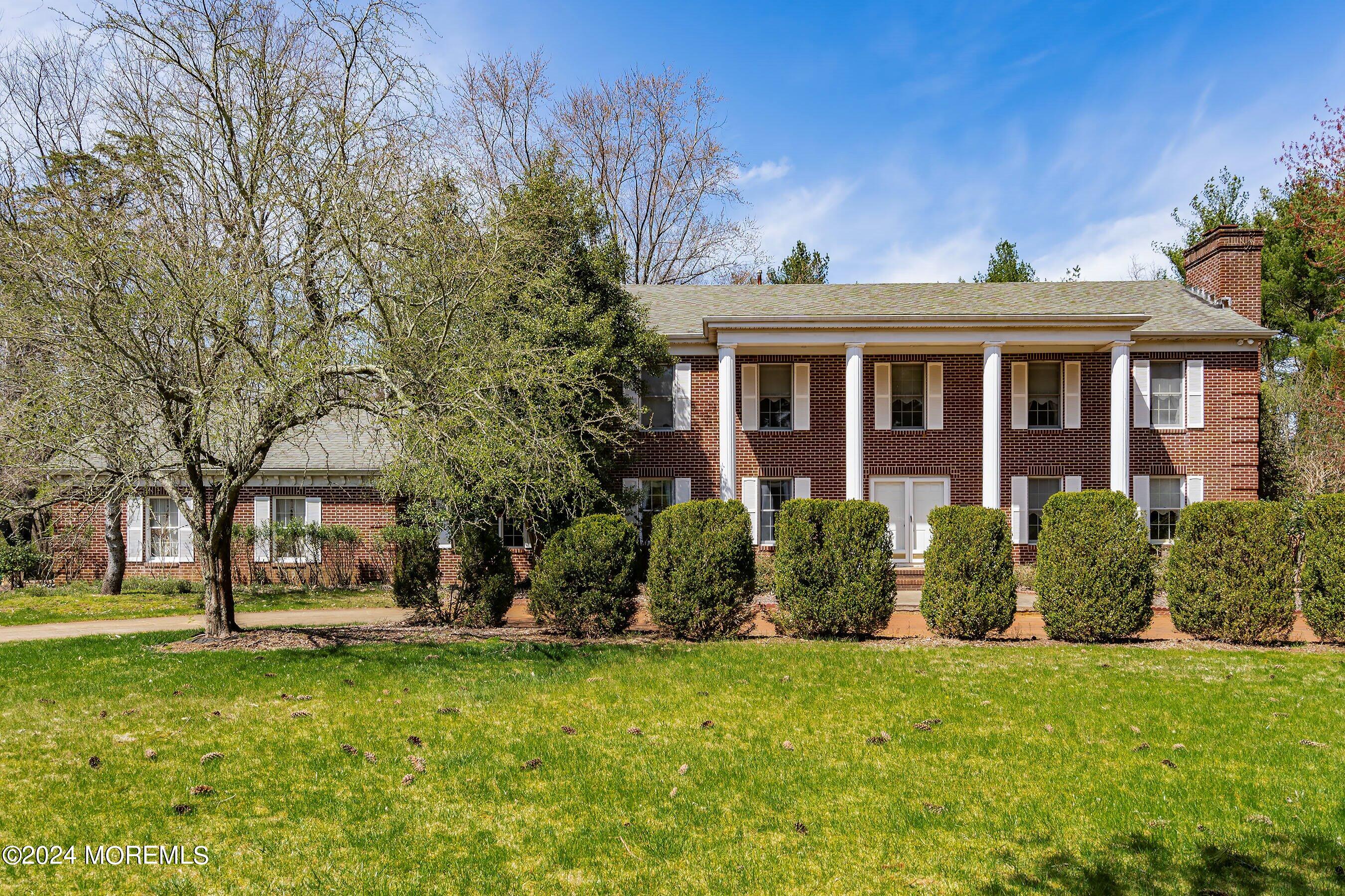 14 Deerpath Lane Colts Neck, NJ 07722 - Photo 1 of 32 a front view of house with yard and green space