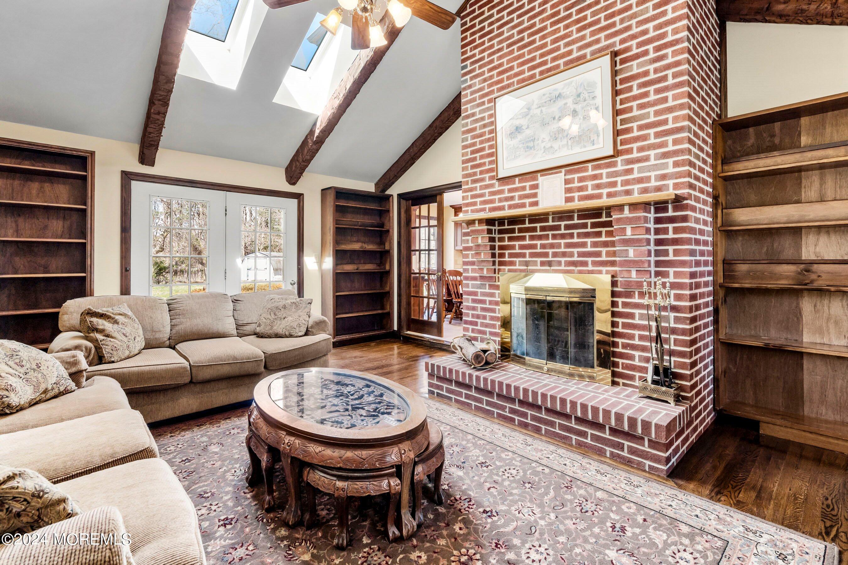 14 Deerpath Lane Colts Neck, NJ 07722 - Photo 14 of 32 a living room with furniture a rug and a fireplace