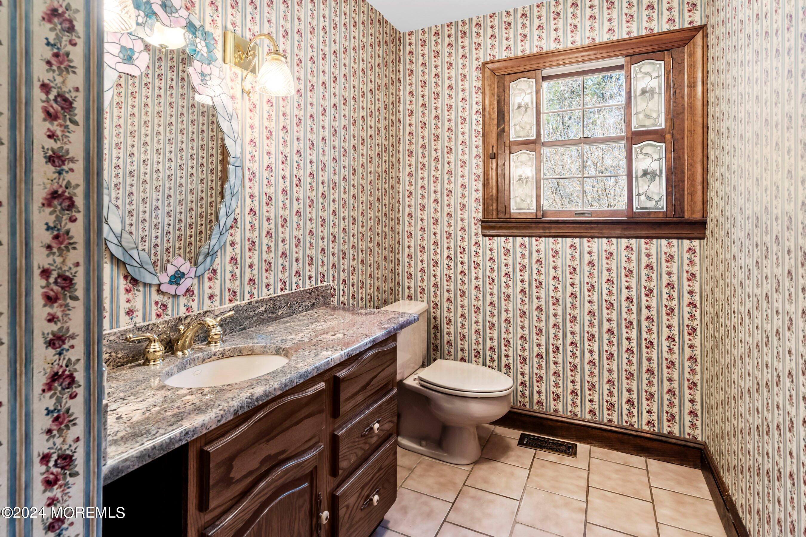 14 Deerpath Lane Colts Neck, NJ 07722 - Photo 16 of 32 a bathroom with a granite countertop sink a toilet and a window
