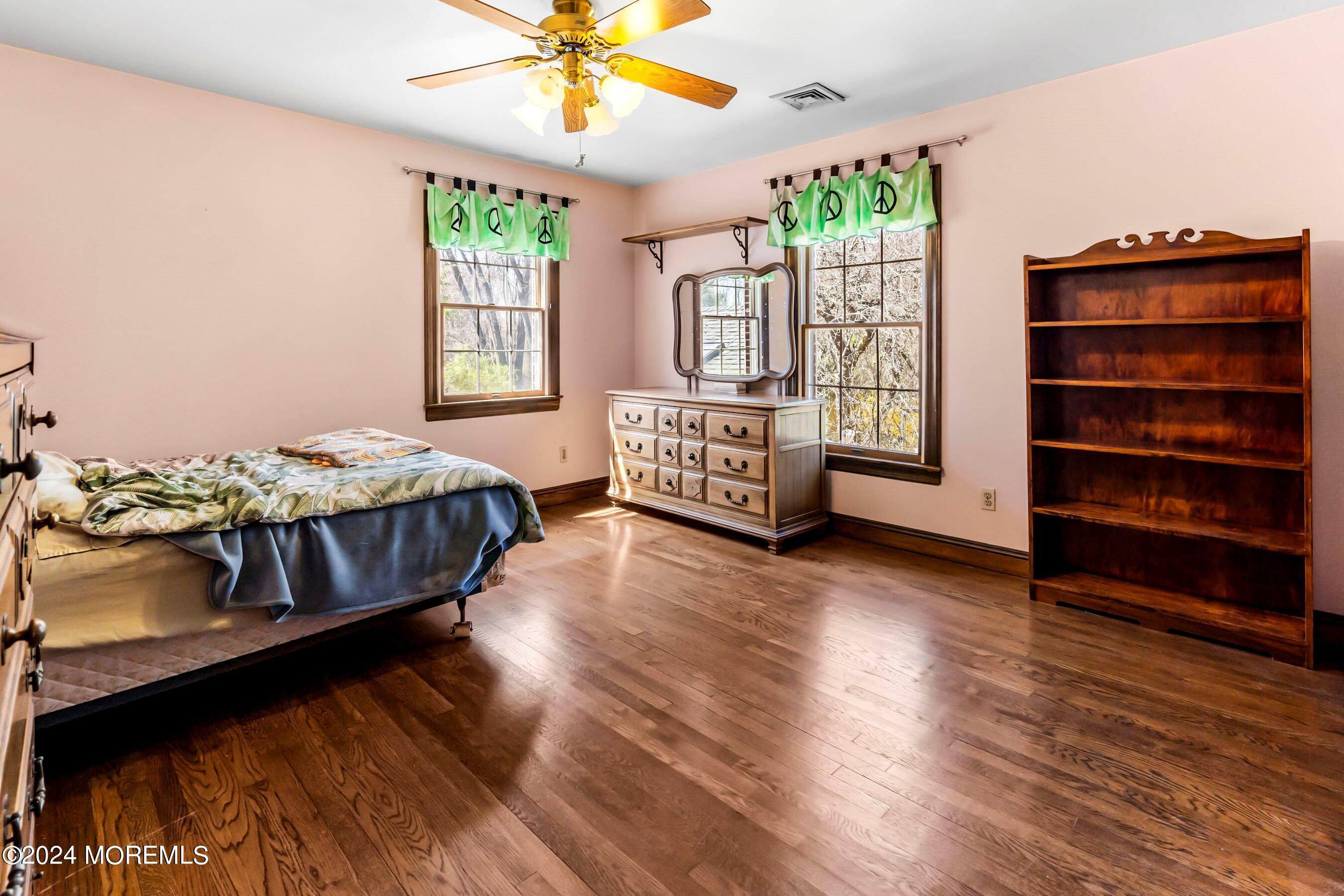 14 Deerpath Lane Colts Neck, NJ 07722 - Photo 25 of 32 a bedroom with a bed closet and a large window