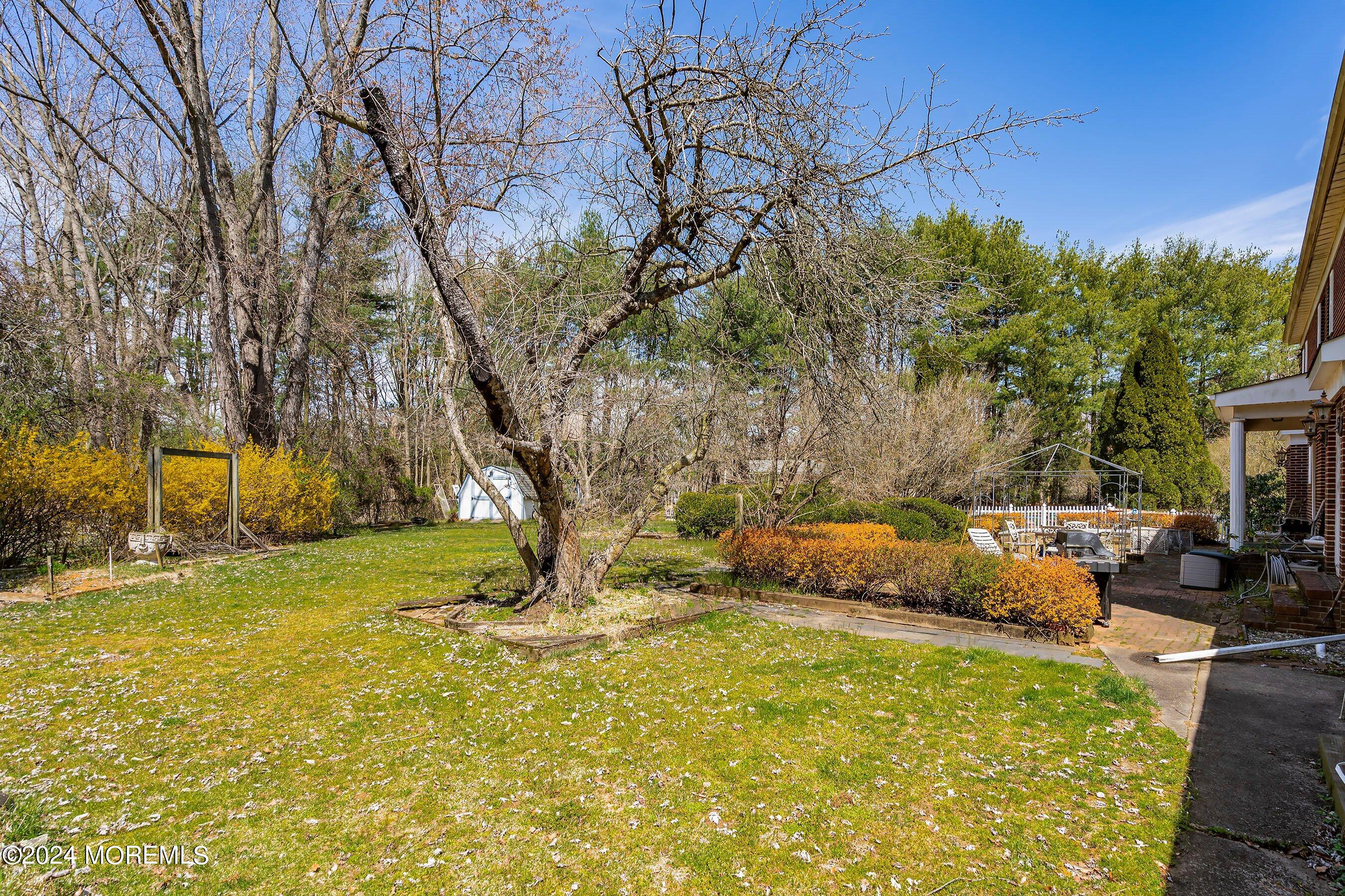 14 Deerpath Lane Colts Neck, NJ 07722 - Photo 29 of 32 a backyard of a house with yard and outdoor seating