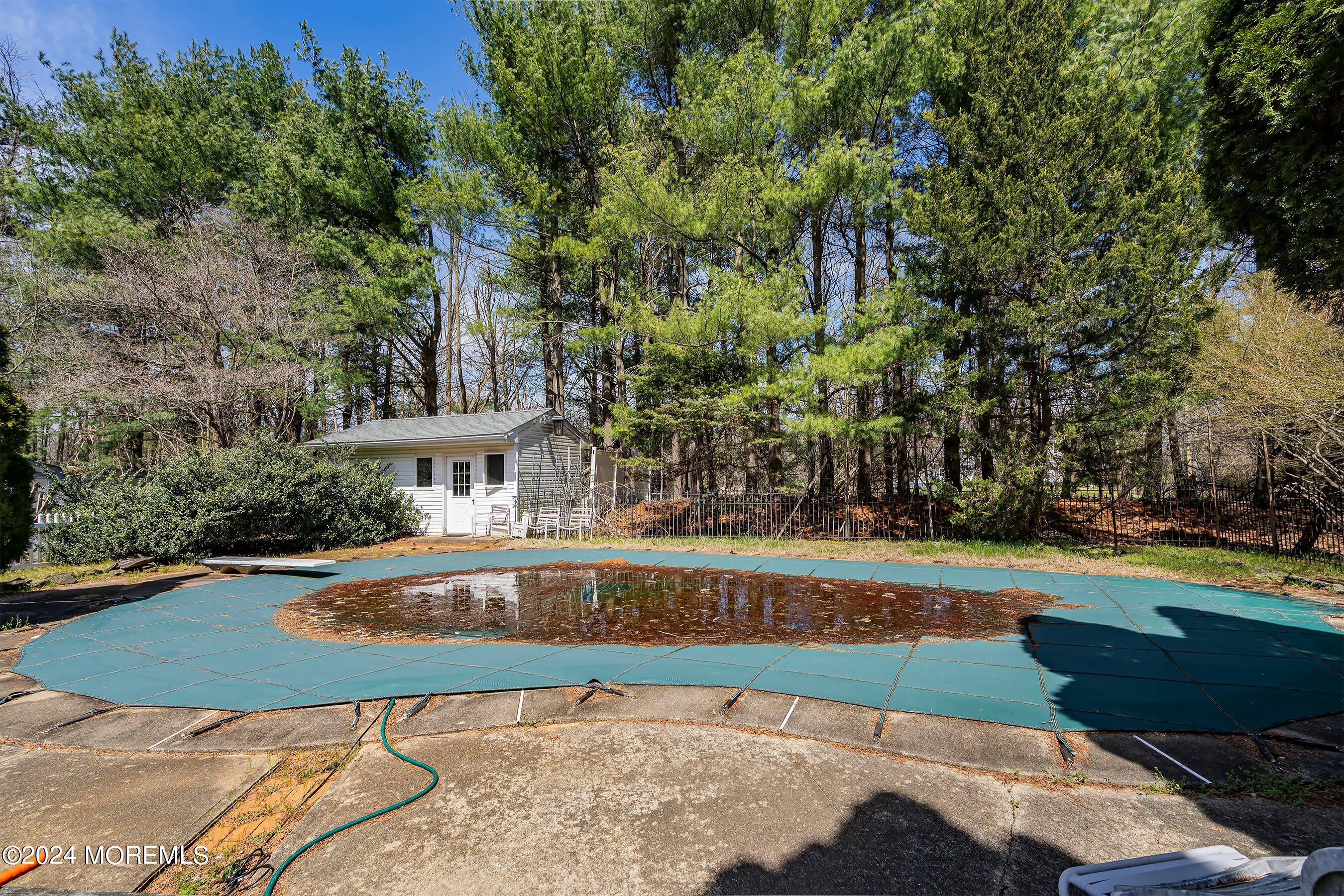 14 Deerpath Lane Colts Neck, NJ 07722 - Photo 30 of 32 a view of a swimming pool with an outdoor space and seating area