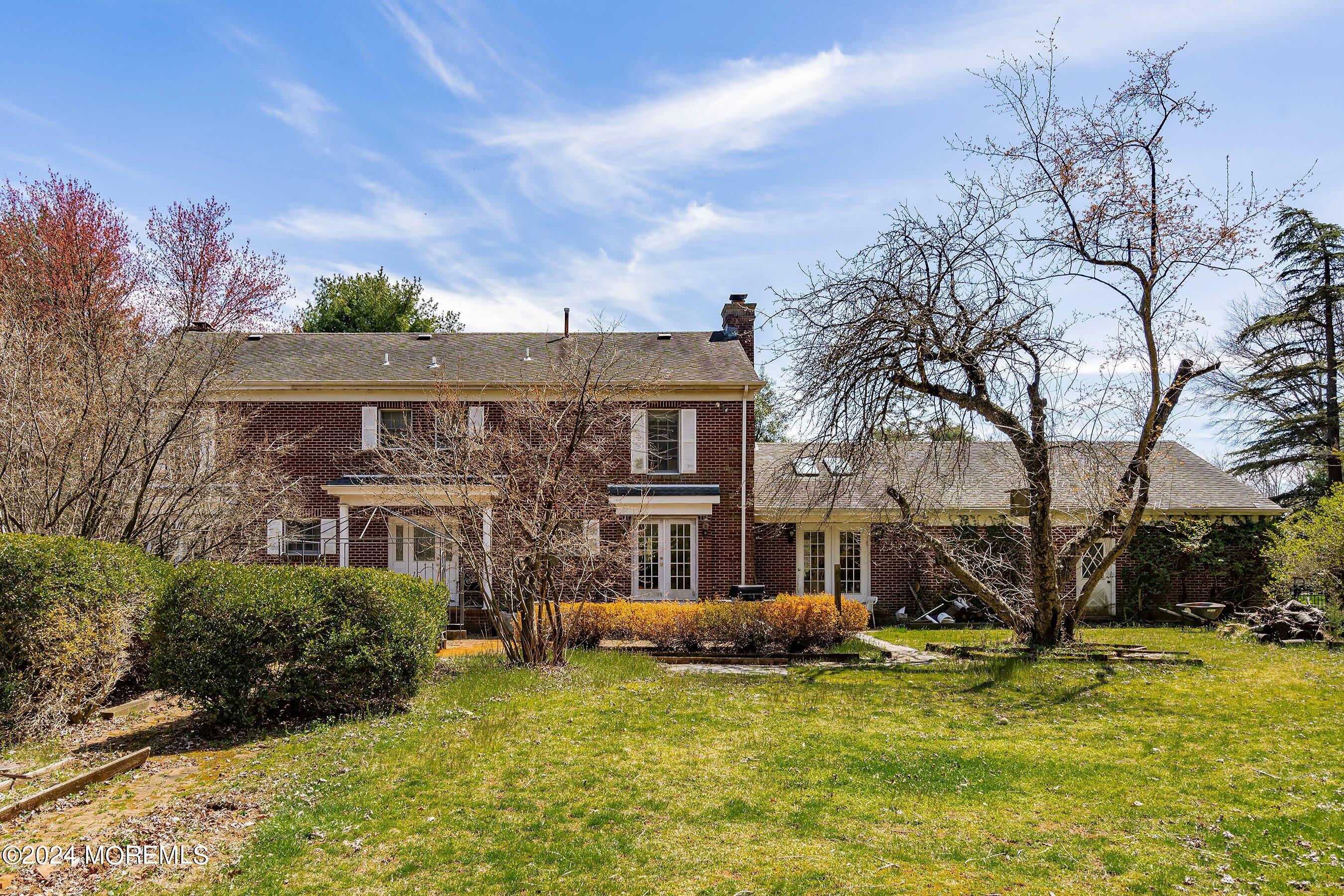 14 Deerpath Lane Colts Neck, NJ 07722 - Photo 32 of 32 a backyard of a house with a garden and tree