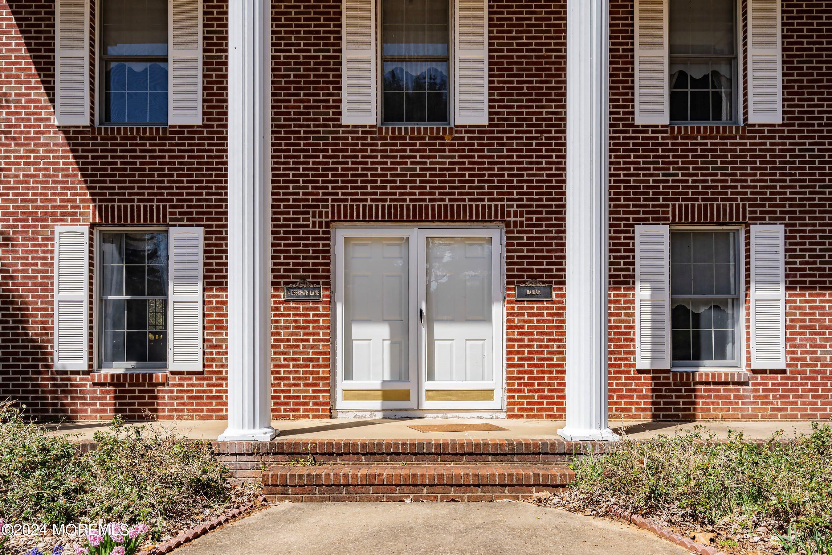 14 Deerpath Lane Colts Neck, NJ 07722 - Photo 5 of 32 a front view of a house having yard