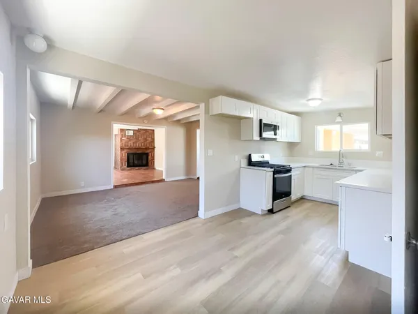 a large kitchen with kitchen island a sink stainless steel appliances and cabinets