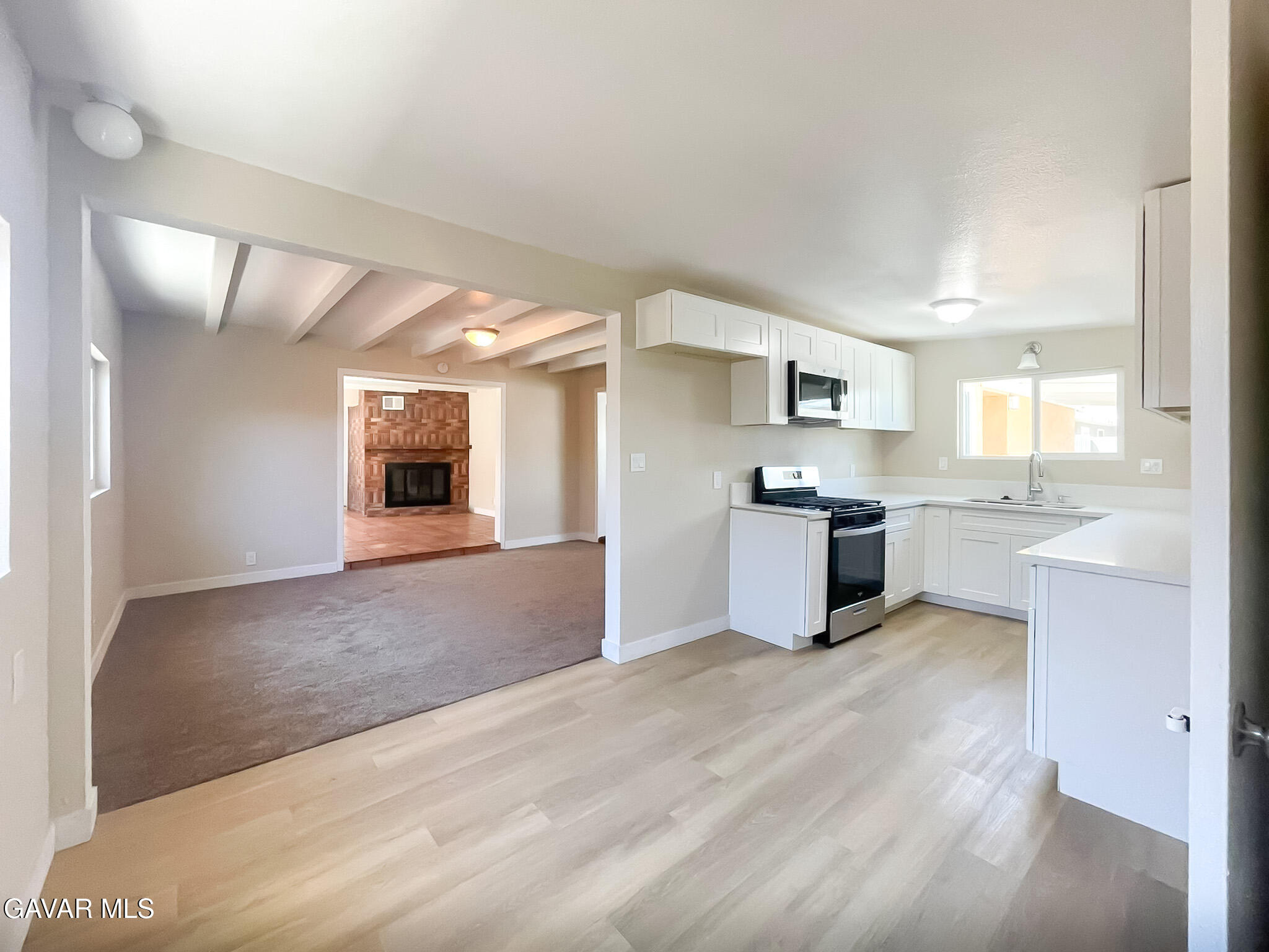 44739 3rd Street East Lancaster, CA 93535 - Photo 17 of 24 a large kitchen with kitchen island a sink stainless steel appliances and cabinets