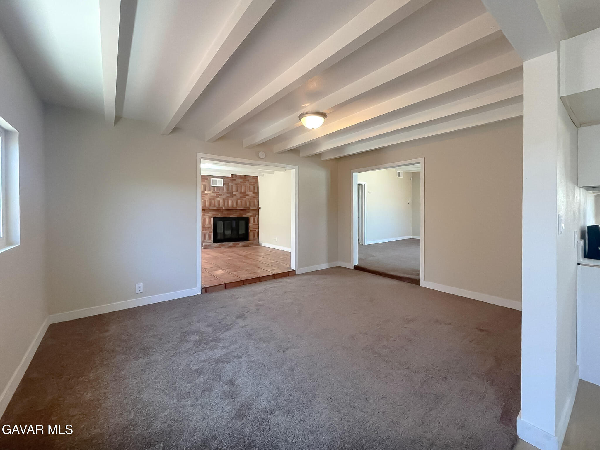 44739 3rd Street East Lancaster, CA 93535 - Photo 18 of 24 an empty room with windows and fireplace