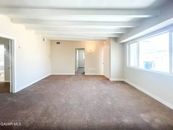an empty room that has a window in it