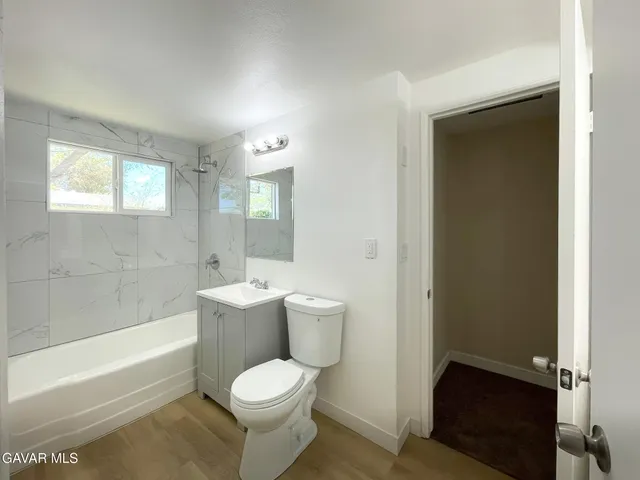 a bathroom with a toilet a sink and bathtub