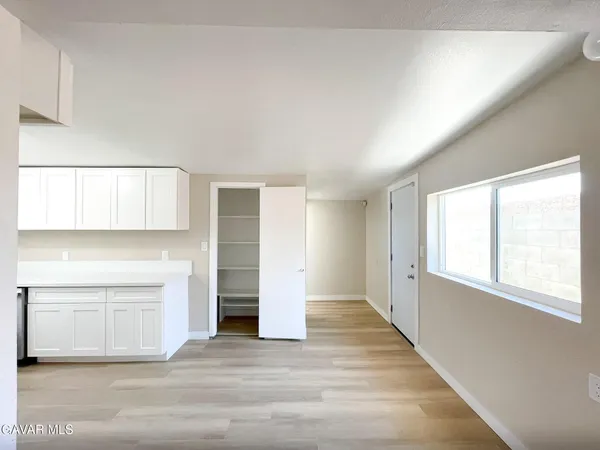 a view of a kitchen with wooden floor and staircase