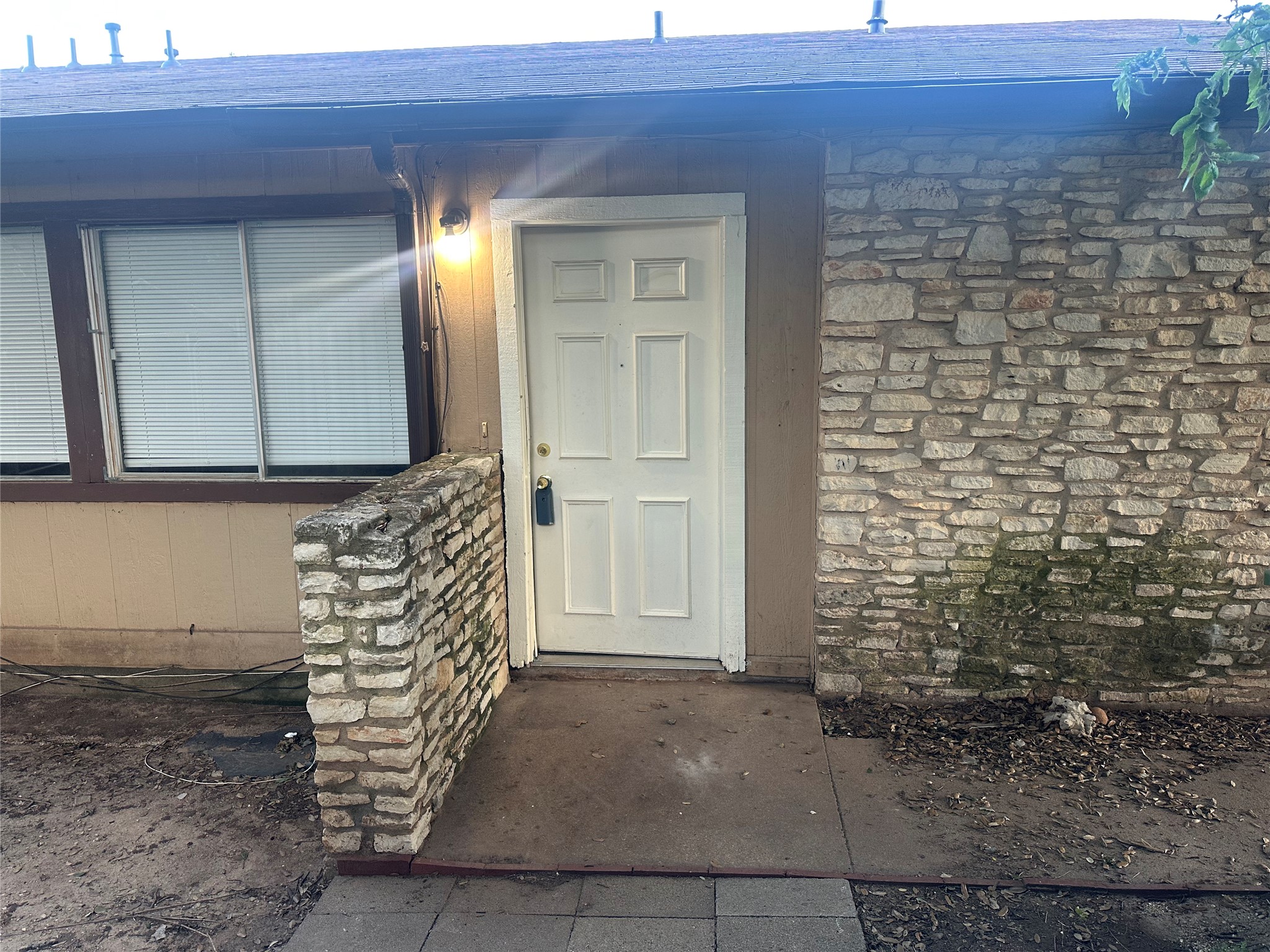 2602 South Bagdad Road, Unit A Leander, TX 78641 - Photo 3 of 26 A well-lit entry welcomes with a solid front door and stone veneer detailing.