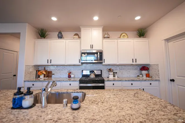 a kitchen with a refrigerator and cabinets