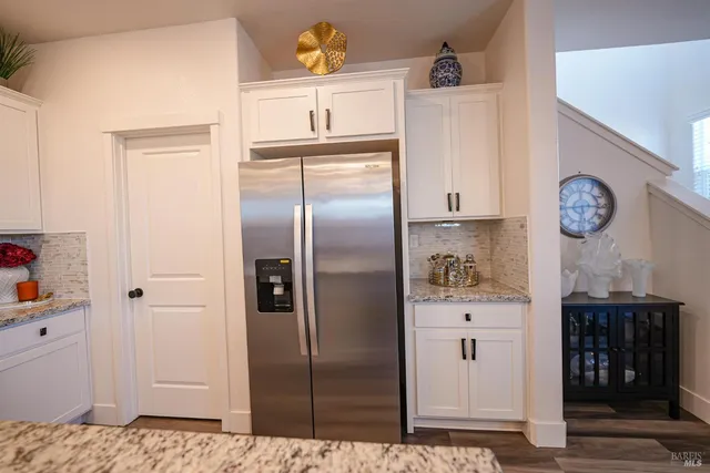 a kitchen with stainless steel appliances cabinets and a refrigerator