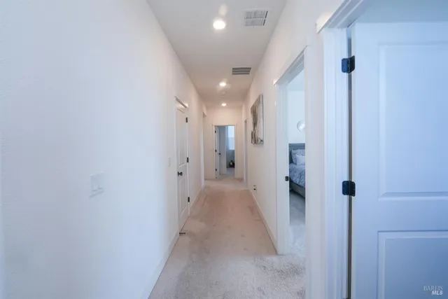 a view of a hallway with a white walls