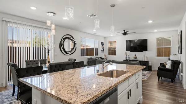 a kitchen with a stove a sink and a refrigerator