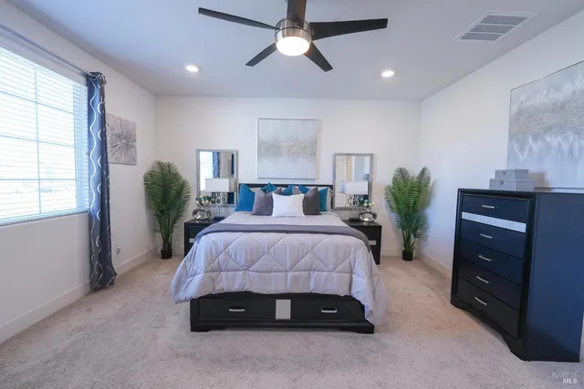 a bedroom with a bed and a potted plant