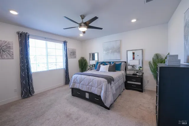 a spacious bedroom with a bed and a window