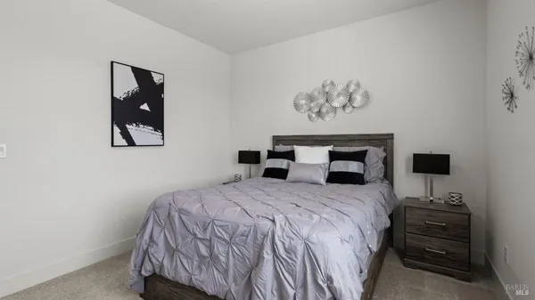 a bedroom with a bed and a painting on the wall