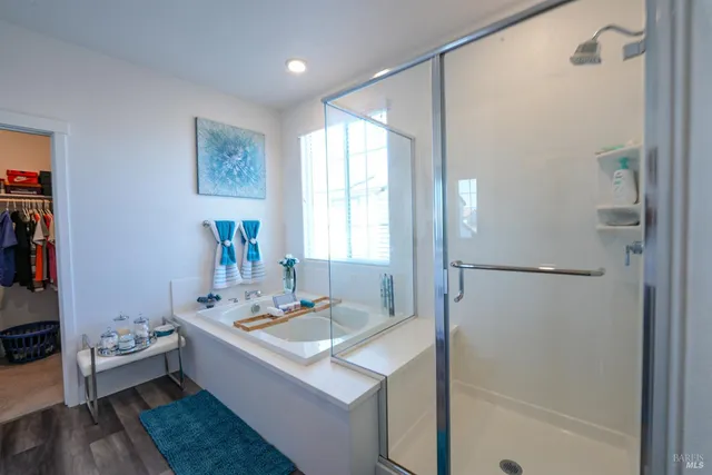 a bathroom with a tub sink and mirror